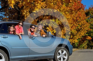Car trip on autumn family vacation, happy parents and kids travel