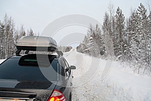 Car trip in winter snowy road