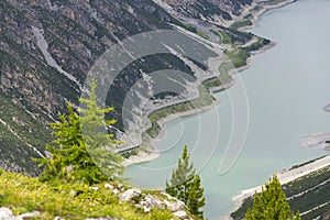 Car tunnel on bank of Livigno Lake in Alps, Ital