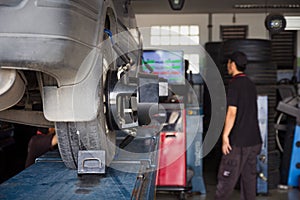 Car tyre alignment wheel balance at garage service workshop. photo