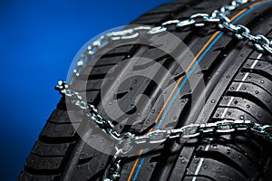 Car tyre with snow chain in the winter