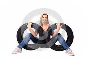 Car tyres and a beautiful woman. Stock Image.