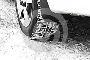 Car tyres on winter road covered with snow