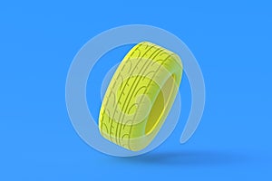 Car tyres of yellow color on blue background. Automotive parts