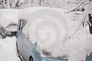 Car under a big snowdrift in winter.