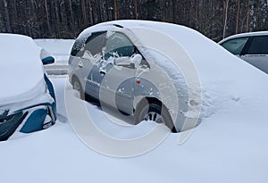 Car under the snow. Heavy snow.