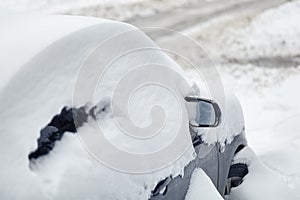Car under snow after snowfall