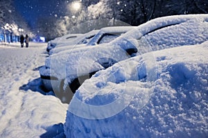 Car under the snow., winter weather vehicle. Cars blocked by snow on roads, street snow-paralysis of traffic.