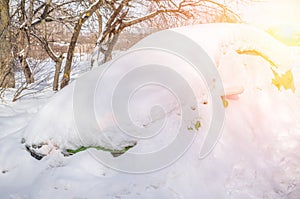 Car under a snowdrift. Winter Parking. Snow drifts in winter