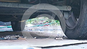 Car undercarriage waiting for mechanic to shock absorber replacement