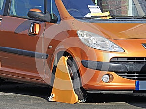 Car vehicle clamped wheel clamp illegal road park parking cars autos tax police notice