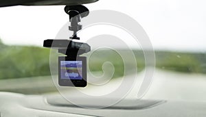 Car video camera dash cam inside of car on highway with blurred background of highway road, from perspective of the driver. Conc