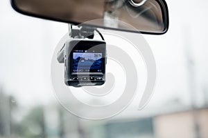 Car video recorder car dash camera.  Video recorder under view mirror in car .Soft focus