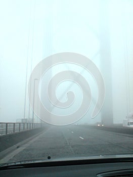 Car view of driving over the forth road bridge during a foggy day