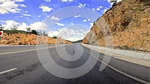 Car view on mountain highway, capturing serene journey along the asphalt path. Drive showcases mountain highway