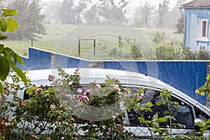 Car in the village during heavy rain