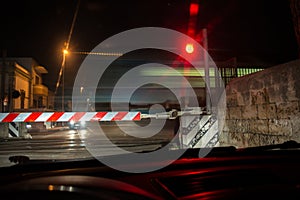 Car Waiting in front of a Rail Crossing