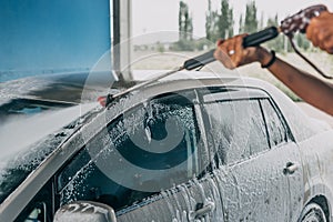 Car Wash closeup. Washing modern bar by high pressure water