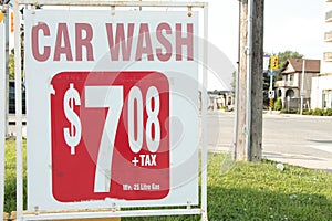 car wash 708 7 dollars plus tax minimum 25 litre gas sign advertisement. ph photo