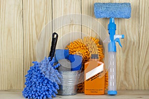 Car wash equipment or car cleaning product such as microfiber tank and glass cleaner and brush with mitts and etc, on wooden tabl