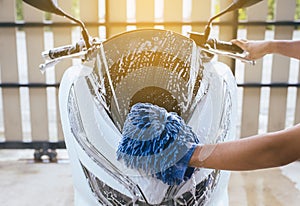 Car wash,Hand men cleaning motorcycle wash foam water at home