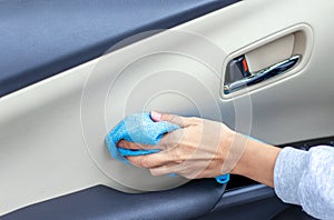 car wash and interior chemical cleaning concept.woman hand use microfiber cloth and spray to clean