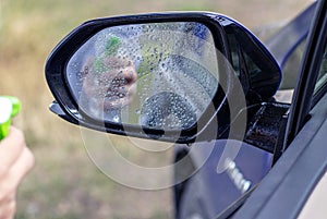 car wash and interior chemical cleaning concept.woman hand use microfiber cloth and spray to clean