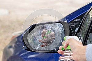 car wash and interior chemical cleaning concept.woman hand use microfiber cloth and spray to clean