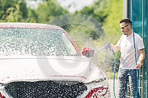 Car wash with soap. Manual car wash with pressurized water in car wash outside.Summe Washing. Cleaning Car Using High Pressure Wat