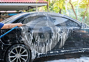Car wash with a water jet at outdoor of home