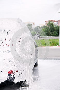 Car washed through a gun with detergent at the sink