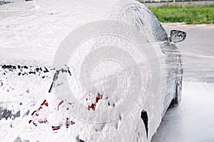 Car washed through a gun with detergent at the sink