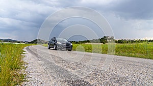 Car on the way among green fields in Phrygia Valley Natural Park Frig Vadisi Tabiat Parki, Ihsaniye, Afyonkarahisar/Turkey photo