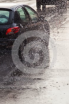 Car on a wet street at heavy rain
