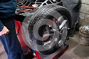 car wheel balancing in tire service garage man rim replace