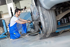 Car wheel change by mechanic