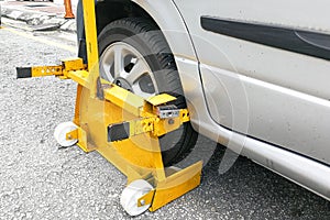 Car wheel clamp on street for illegal parking