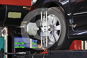 Car wheel fixed with computerized wheel alignment machine clamp