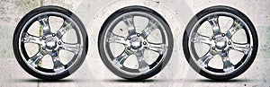 Car wheel on gray concrete background. Copy space. Transport. Spare parts.