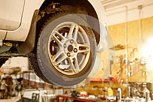 Car wheel on a lift in a car service.