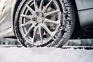 Car wheel in the snow . Driving in winter concept, ai generated