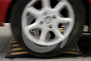 Car wheel and speed bumps closeup