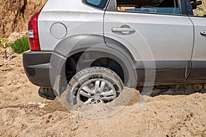 Car wheel stuck in the sand