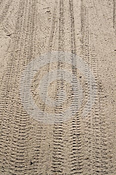 Car wheel trail on the beach sand
