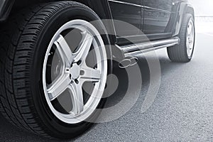 Car wheels close up on a background of asphalt. Car tires. Car wheel close-up