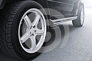 Car wheels close up on a background of asphalt. Car tires. Car wheel close-up photo