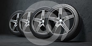 Car wheels. Four new black tyres with alloy discs in garage