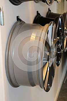 Car wheels hanging on a wall.