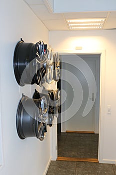 Car wheels hanging on a wall.