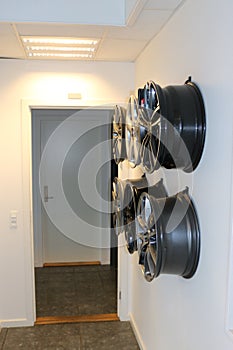 Car wheels hanging on a wall.